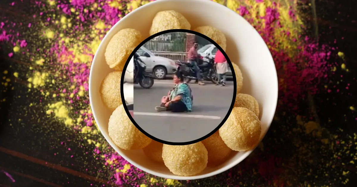 woman sits in the middle of the traffic in vadodara for Panipuri