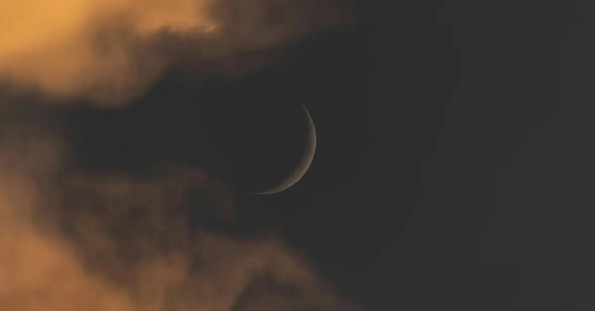 Newmoon amidst dark clouds